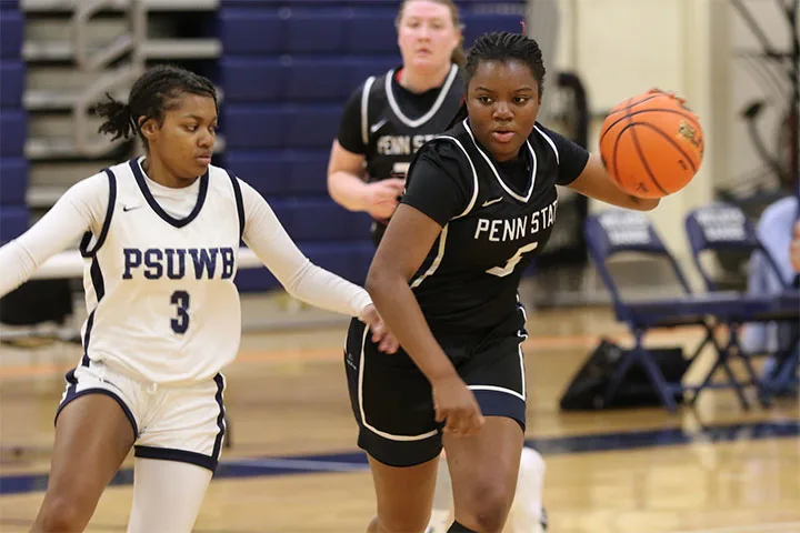 Photo of a player on the Hazleton women's basketball team dribbling the ball in a game