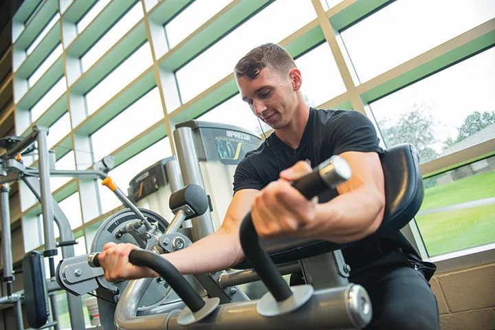 Photo of a student working out at an on-campus gym