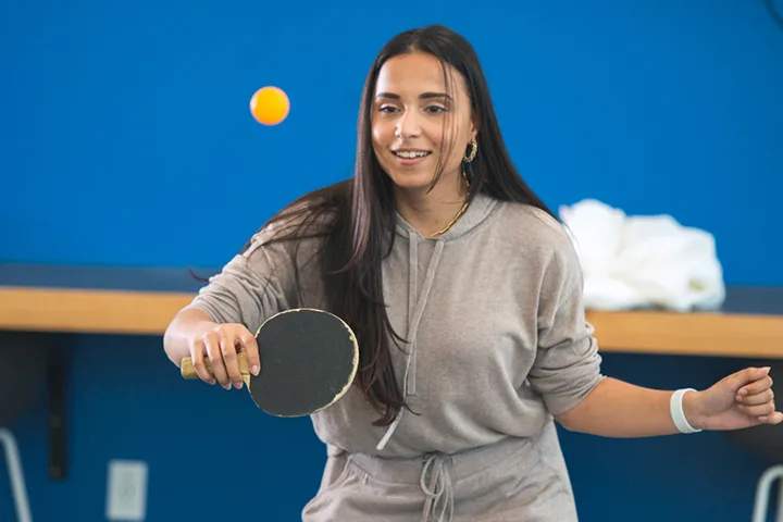 photo of a student holding a ping pong paddle