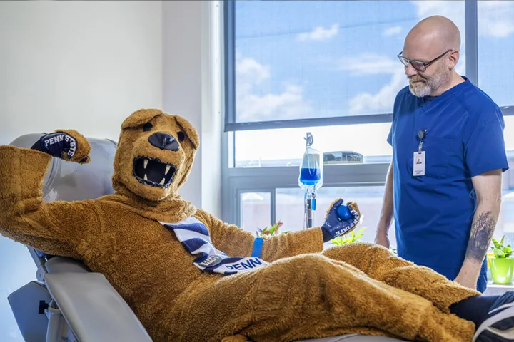 Penn State's Nittany Lion mascot in a patient room, waiting on a table for a health exam