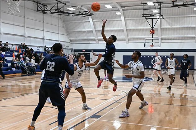 Basketball player shooting a shot during a game.