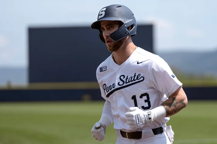 photo of a Penn State baseball player in uniform with a batting helmet on