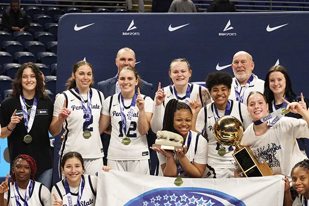 Photo of the Beaver women's basketball team with medals and a trophy