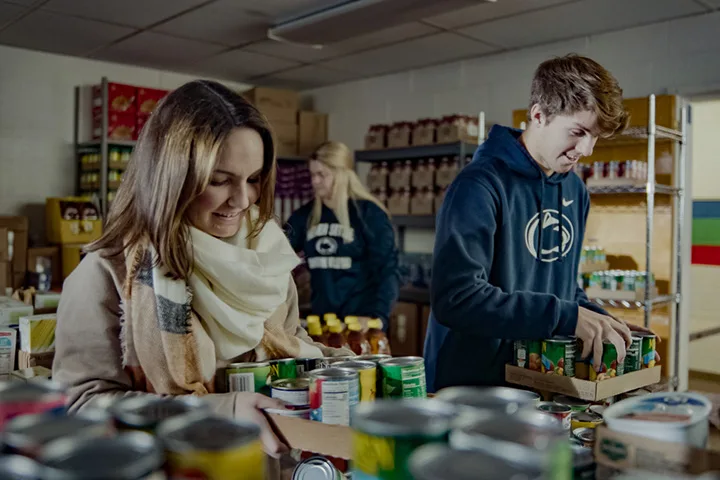 Students organizing cans in a local food bank