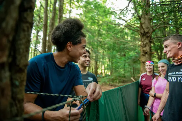 Photo of students in the AURORA program setting up a tent