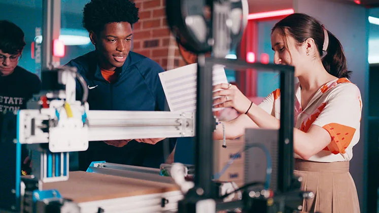 Photo of students working together in the Makerspace