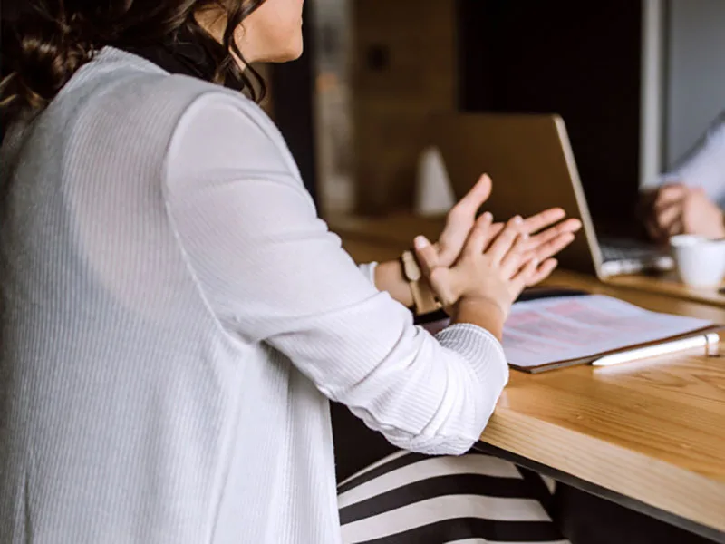 Staff member at desk talking