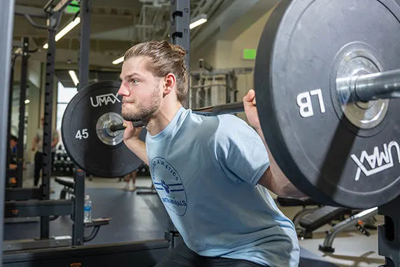 Photo of a student lifting weights