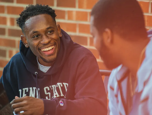 Two men discussing Penn State