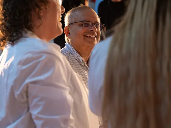 Pisupati laughing and talking with two people