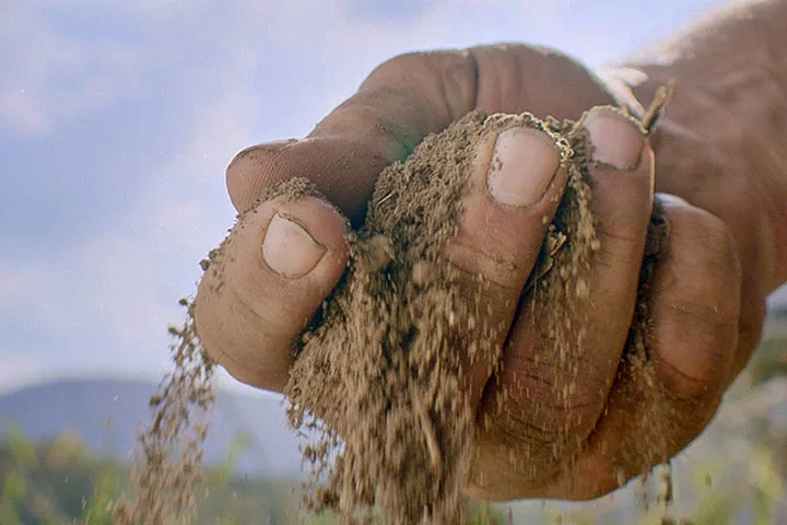 Close-up photo of a hand full of soil