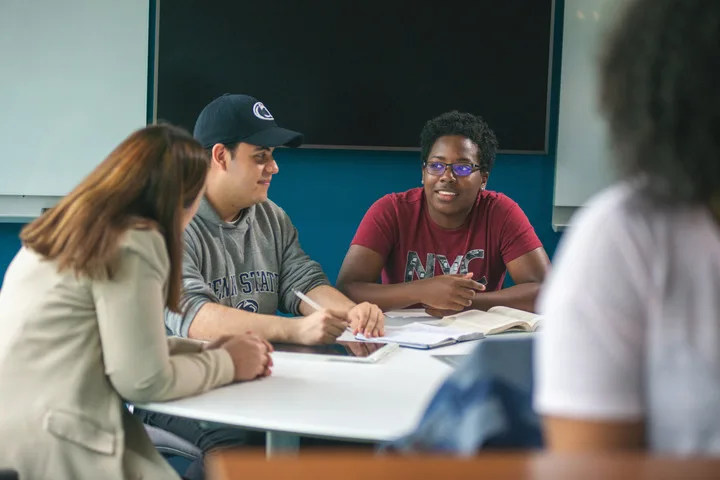 Three students working together in class