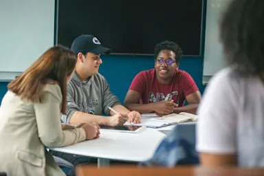 Three students working together in class