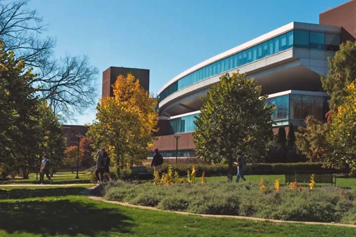 Photo of the Westgate Building on a sunny day with students walking past