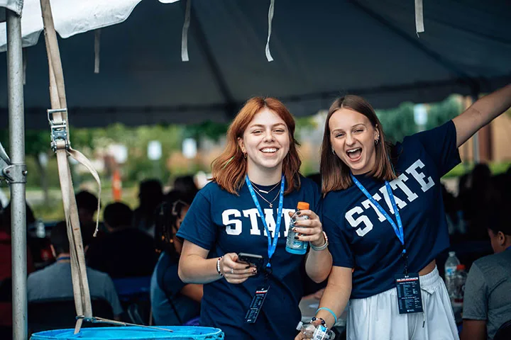 Photo of two students smiling at an event