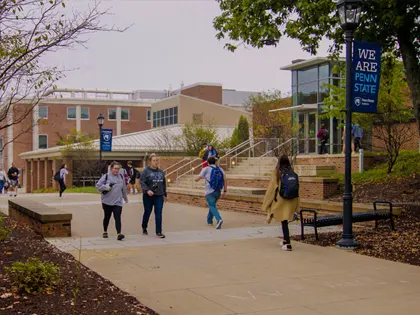 A large group of people walking on campus at Penn State Hazleton.