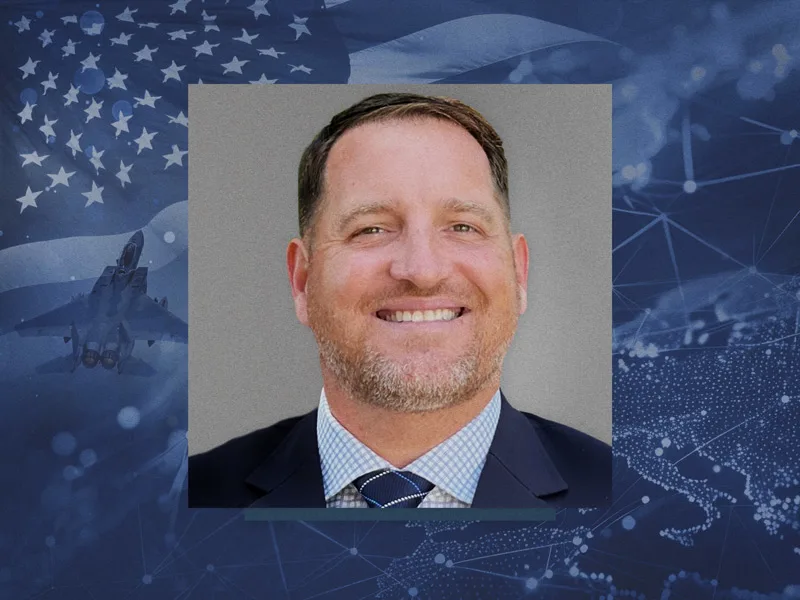 Malcom Warbrick's headshot overlayed on a background of military planes and symbols.