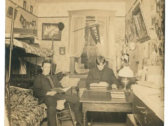 A historic photo of two students in a residential room