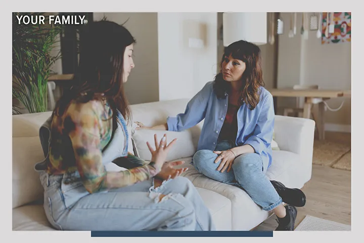Two people having a conversation in a home. There is an overlay that says: Your Family