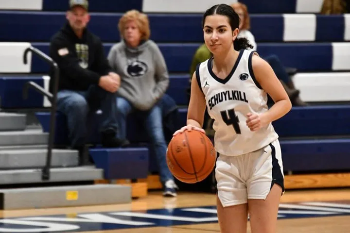 Photo of a player on the Schuylkill's women's basketball team dribbling in a game