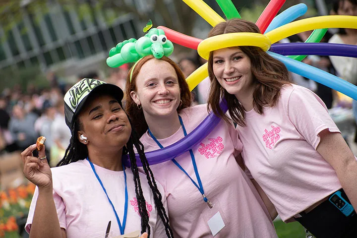 Photo of students with balloon art at an involvement fair