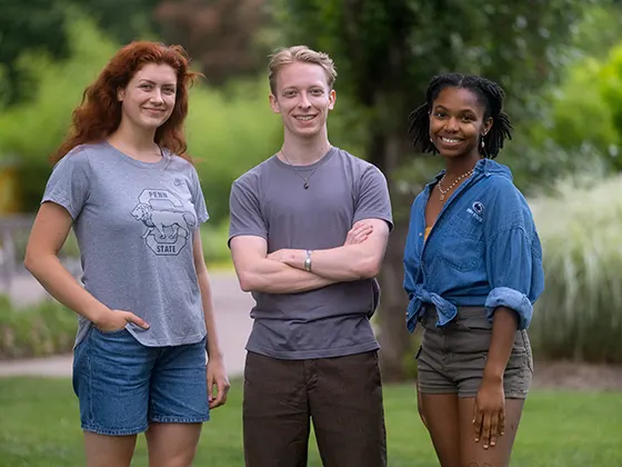 Three students posed in the arboretum