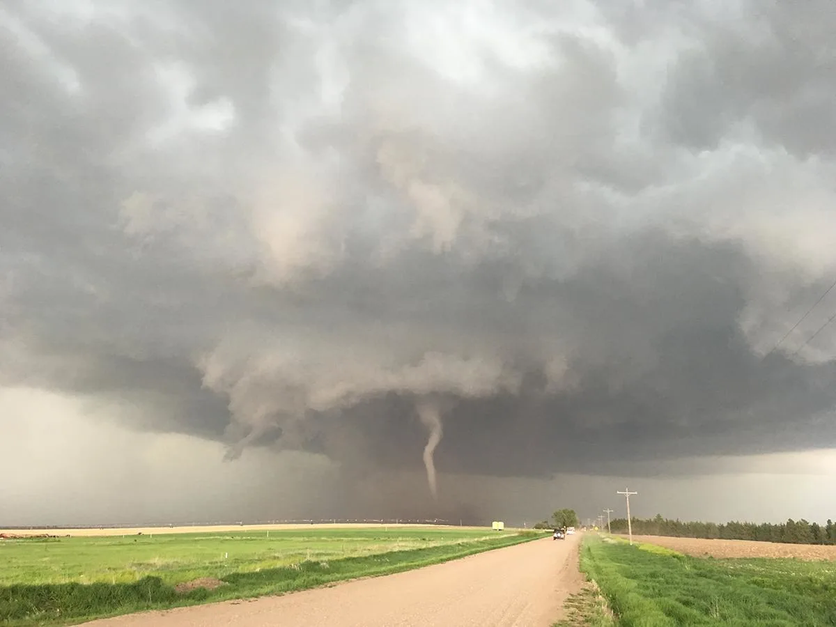 How does atmospheric turbulence impact tornado formation?