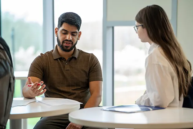 A manager and student talking