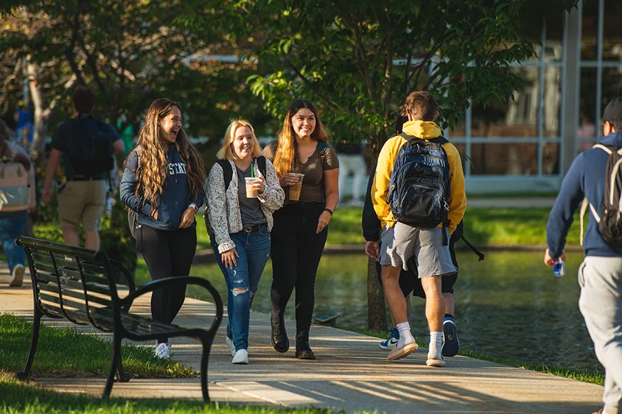 A group of students walking near a pond at Penn State Altoona