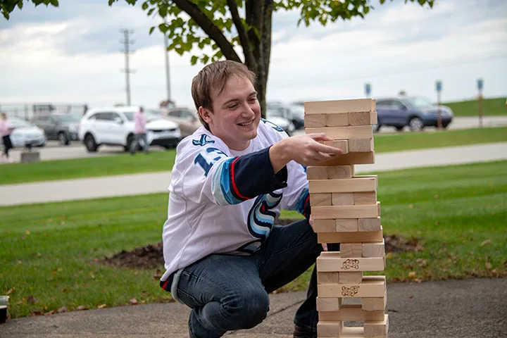 Photo of a student playing lawn Jenga