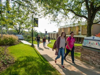 A group of people walking on campus at Penn State New Kensington.