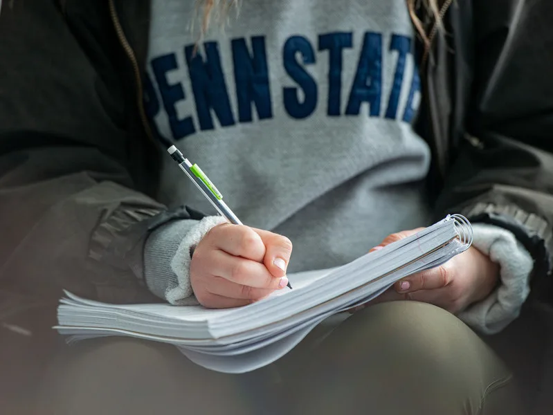 Student writing in a notebook