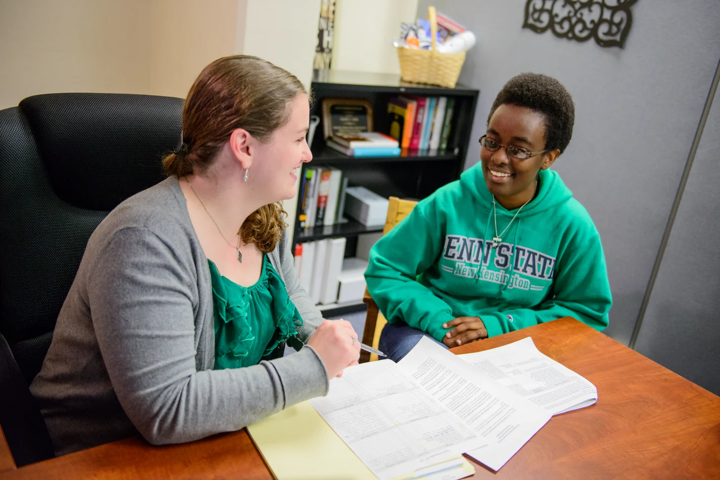 Student and employer working at desk.