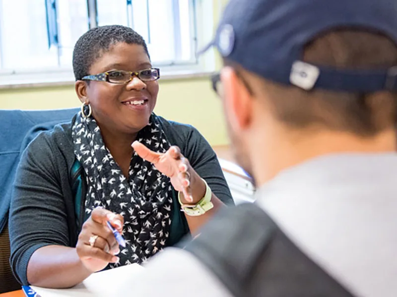 A Penn State faculty member has a discussion with a student