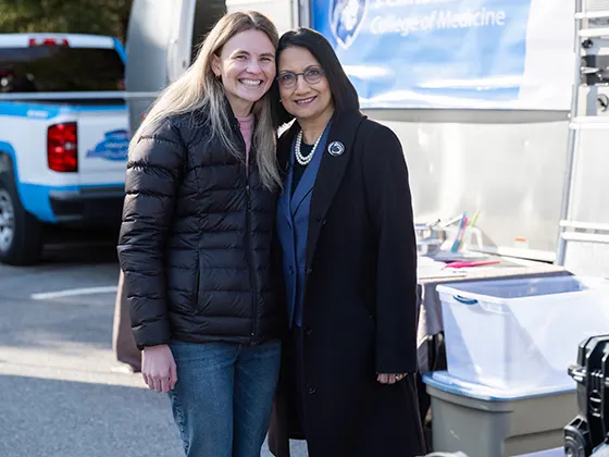 Neeli Bendapudi and a student at a mobile medical setup 