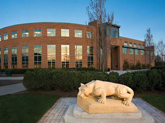 Photo of the lion statue at Penn State Harrisburg with a building in the background