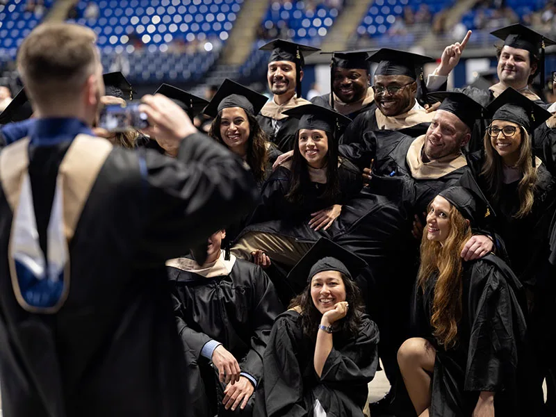 Penn State students take graduation photo.