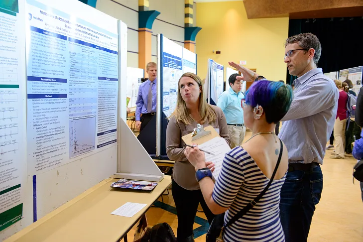 Image of students speaking with a professor.