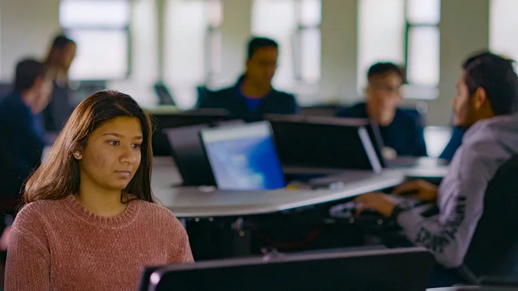 Photo of students working on computers in a classroom