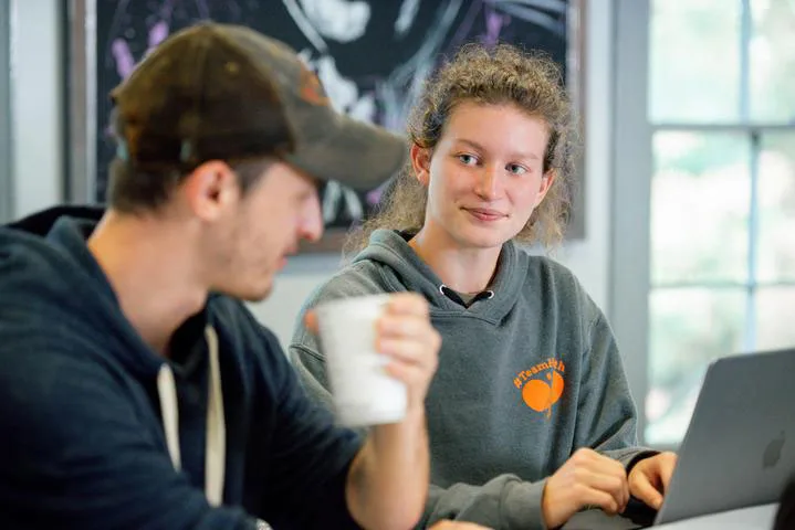 Photo of two students sitting and talking