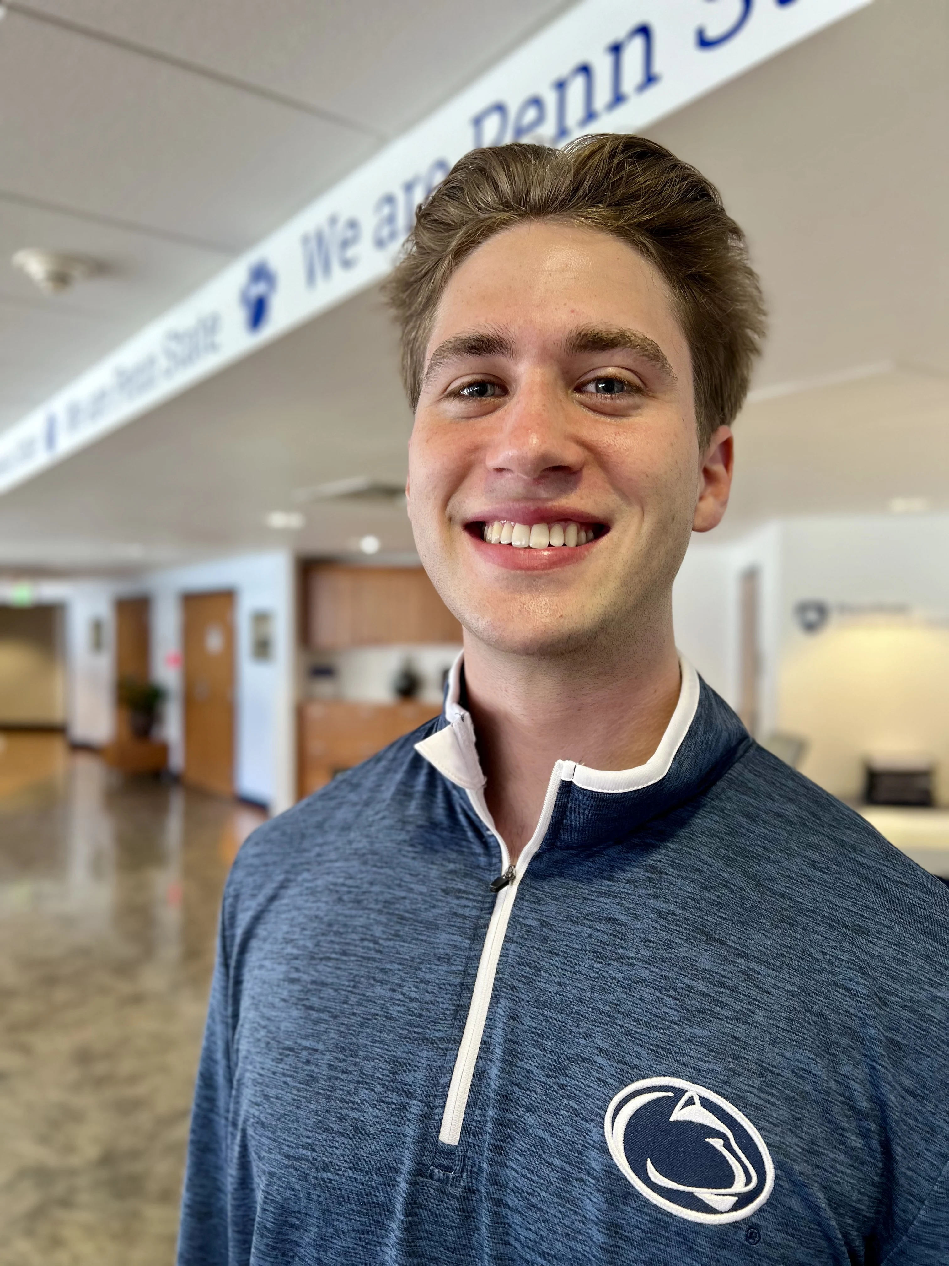 Grant headshot wearing navy and white Penn State shirt