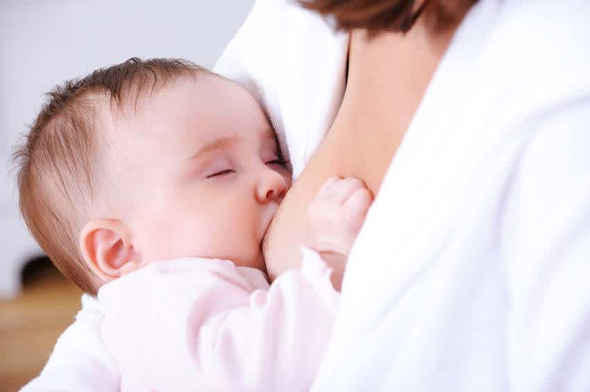 Breastfeeding baby with closed eyes