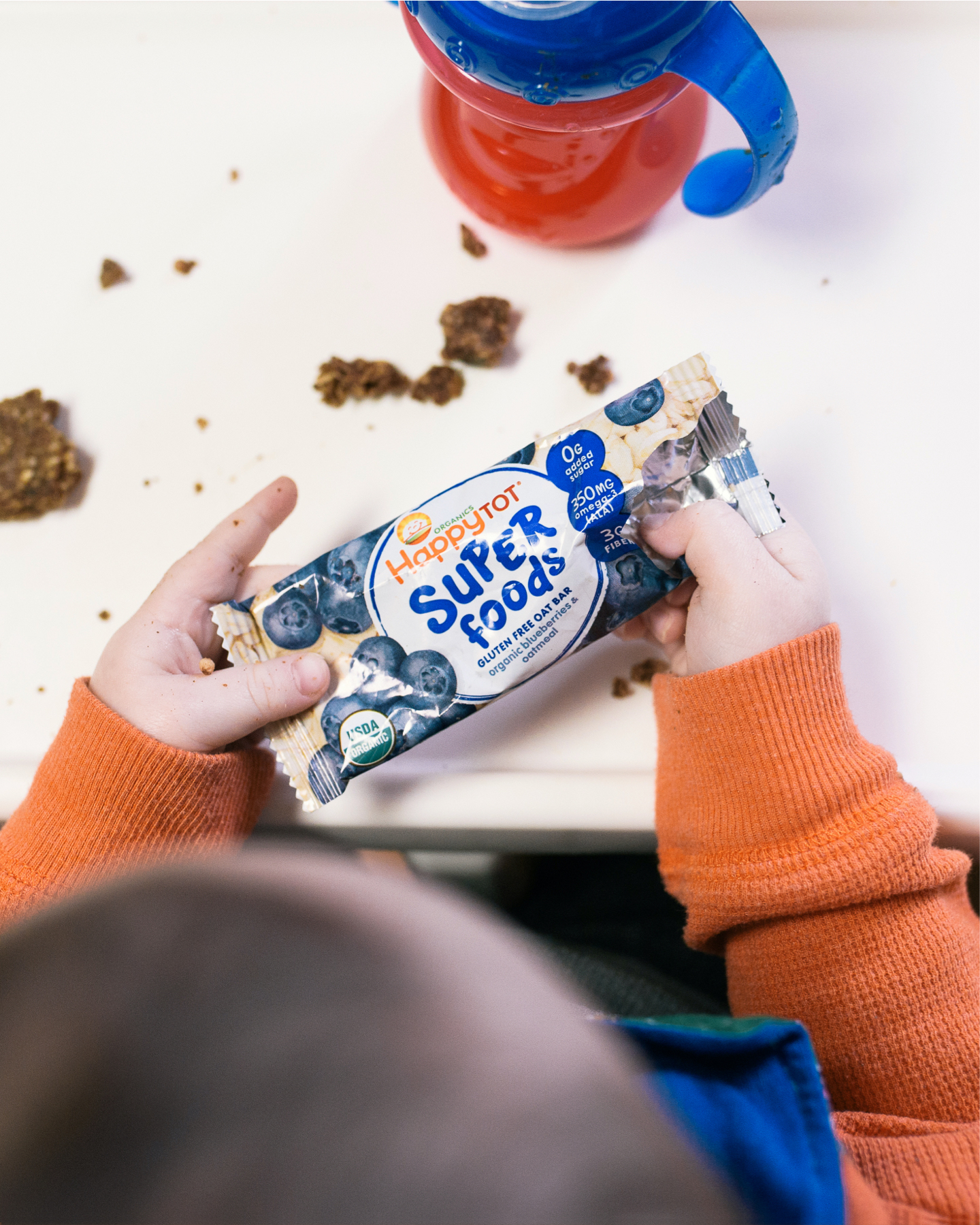 Child holding superfoods bar.