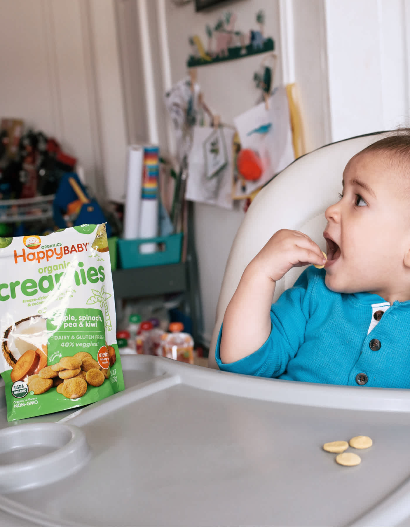 Baby snacking in highchair.