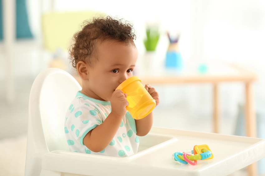 Baby drinking water from sippy cup