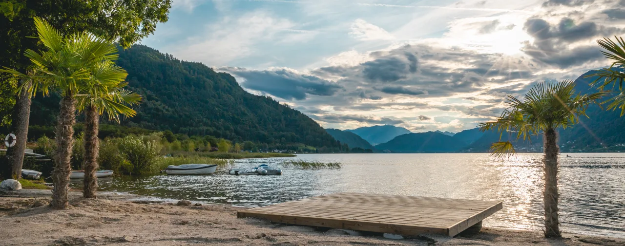 EuroParcs Ossiacher See Austria Carinthia Beach Lake Water Boat Palm trees Mountains Sun