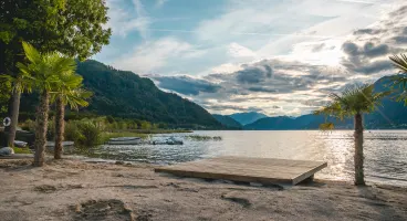 EuroParcs Ossiacher See Austria Carinthia Beach Lake Water Boat Palm trees Mountains Sun