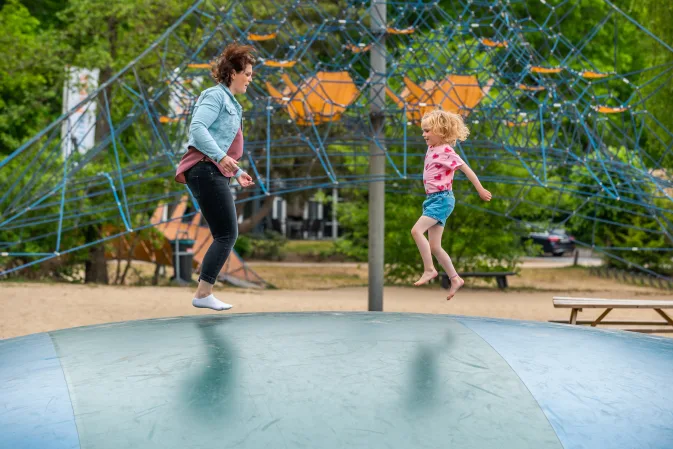 Kind speelt met moeder in speeltuin op vakantiepark EuroParcs De Zanding