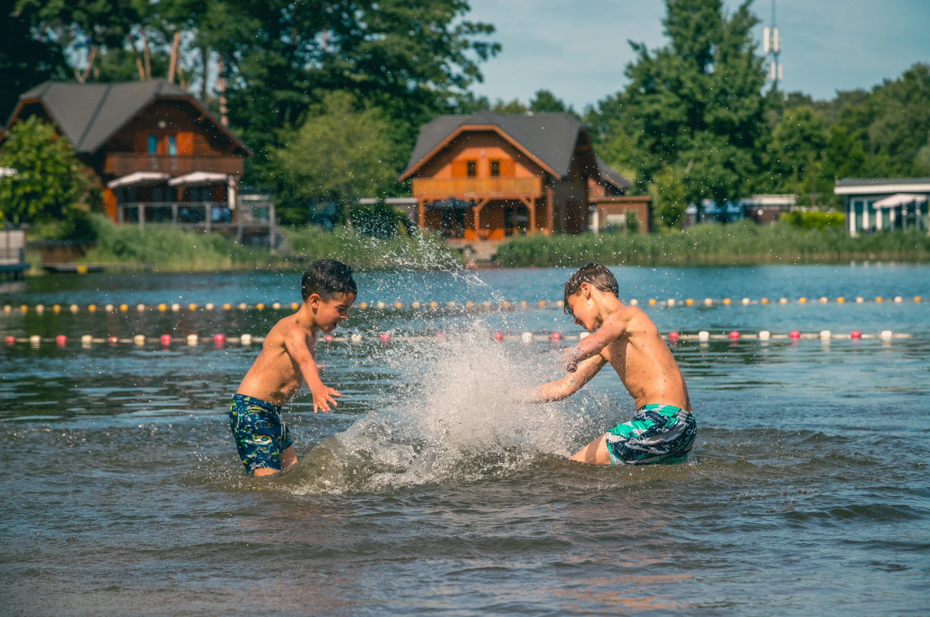 Children playing in lake at holiday park EuroParcs Brunsummerheide 