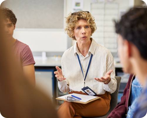 A patient financial counselor speaks with a group in a meeting room